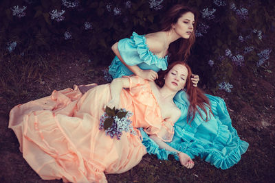 High angle view of young women sitting on grass