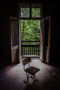 Empty chair in abandoned house