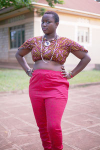 Full length of woman with pink hair standing outdoors