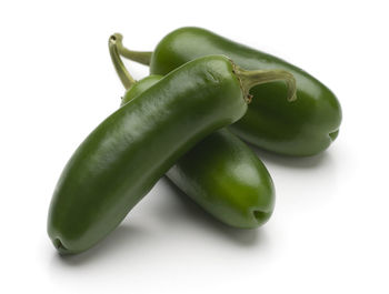 Close-up of green pepper against white background