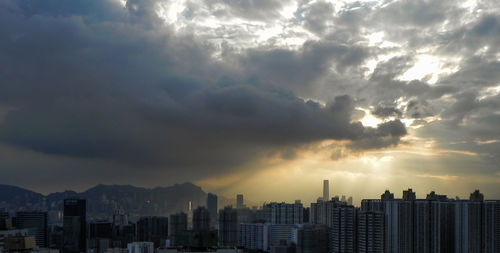 View of cityscape against cloudy sky