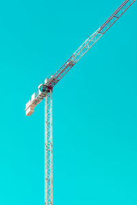 Low angle view of crane against clear sky