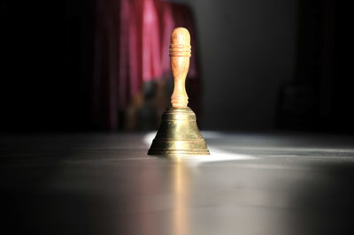 Close-up of illuminated light bulb on table