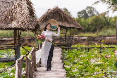 Rear view of woman standing by plants