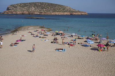 People on beach against sky