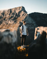 Full length of woman standing on rock