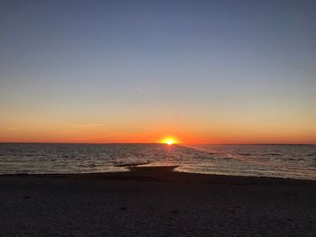 Scenic view of sea against clear sky during sunset