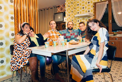 Portrait of family sitting at dining table