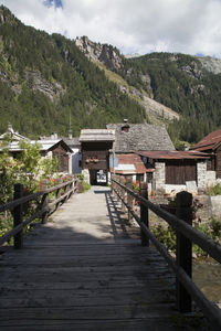 Scenic view of house and mountains against sky