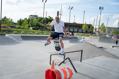 Rear view of man skateboarding on skateboard