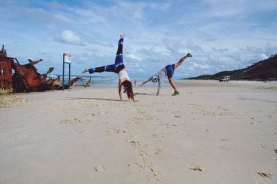 People on beach against sky