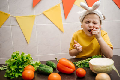 Girl in rabbit ears eat herb dill vegetables easter copy space. high quality photo