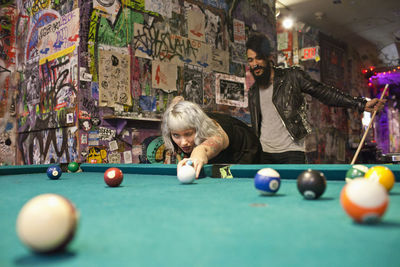 Young couple playing pool