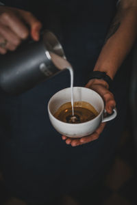 Midsection of man holding coffee