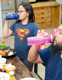 Full length of a woman drinking water