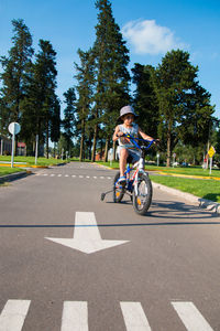 Boy riding bicycle urban scene