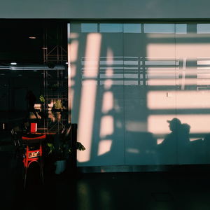 Reflection of people on glass window at restaurant