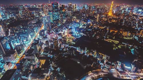 High angle view of illuminated city buildings at night