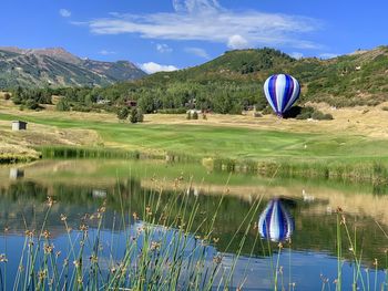 Scenic view of ball by lake against sky