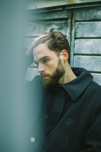 Portrait of man adjusting hair