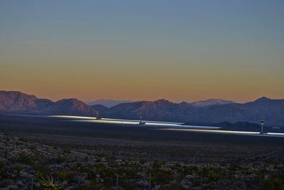 Scenic view of mountains against clear sky during sunset