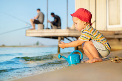 Cute boy sitting in water