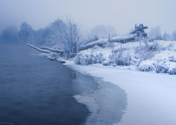 Frozen lake against sky during winter