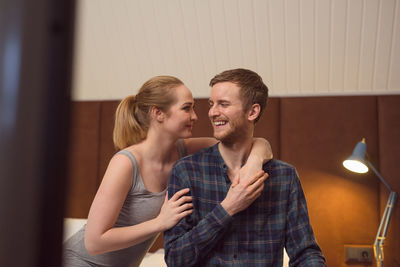 Young couple hugging in bedroom