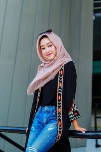 Portrait of young woman hijab standing in gym
