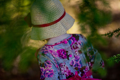 Rear view of child standing against blurred background