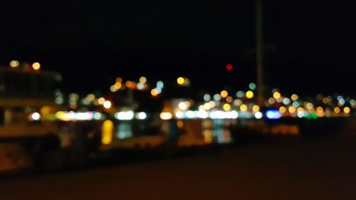 Defocused image of illuminated city street at night