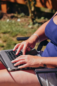Midsection of man using mobile phone on table