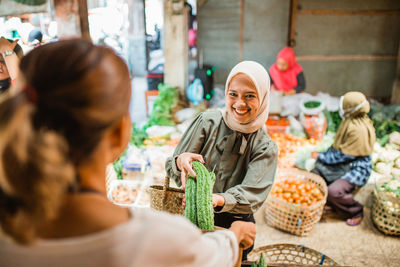 Rear view of woman holding food