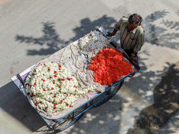 High angle view of a flower garlands seller on street