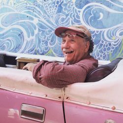 Portrait of smiling man sitting in car