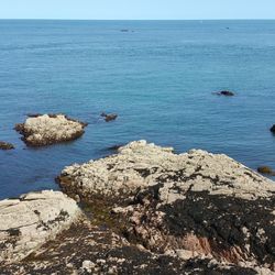 High angle view of rock formation in sea against sky