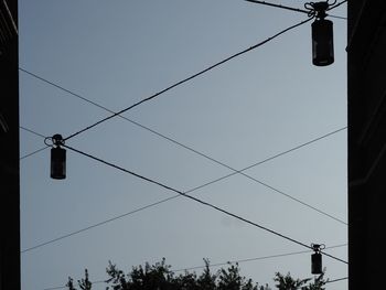 Low angle view of electricity pylon against sky