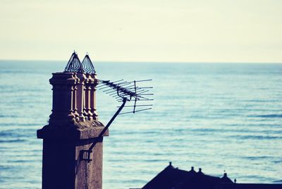 Antenna on tower against seascape