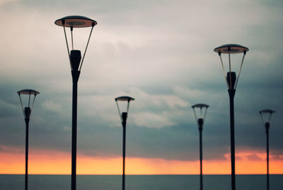 Low angle view of street light against sky at sunset