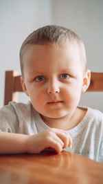 Close-up of cute baby boy sitting on table