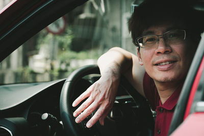 Close-up portrait of man sitting in car