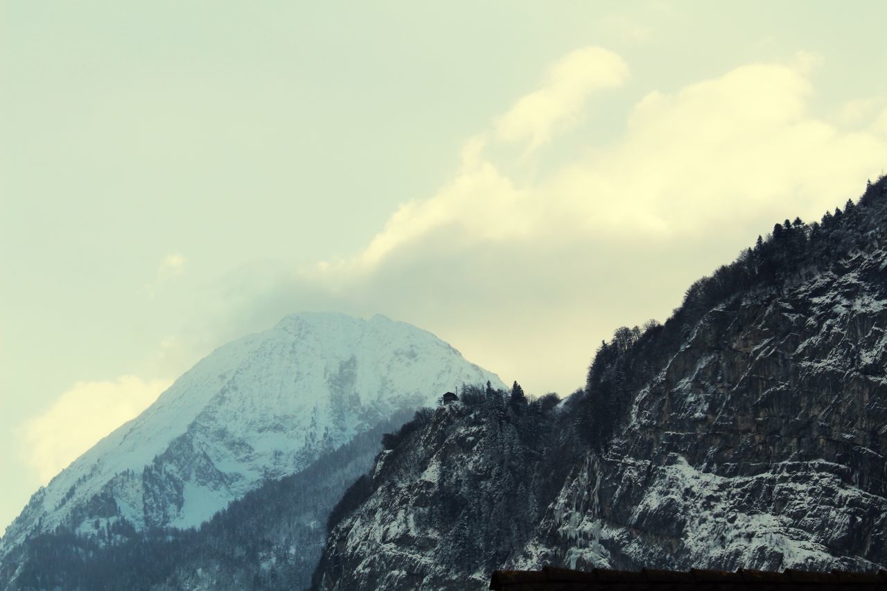 mountain, snow, scenics, winter, tranquil scene, cold temperature, sky, tranquility, beauty in nature, mountain range, weather, nature, cloud - sky, season, rock - object, rocky mountains, non-urban scene, low angle view, landscape, idyllic