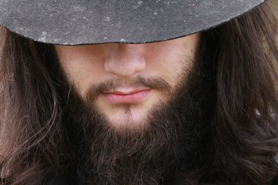 Midsection of bearded man wearing cowboy hat
