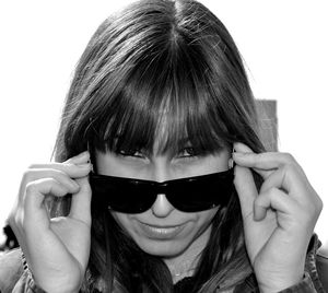 Portrait of woman wearing sunglasses against white background