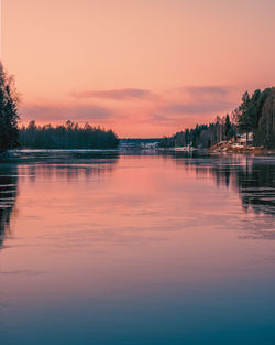 Scenic view of lake against romantic sky at sunset