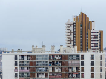 Buildings in city against clear sky