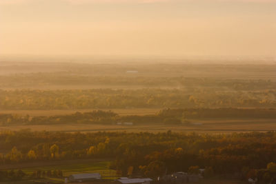 Scenic view of field against sky during sunset