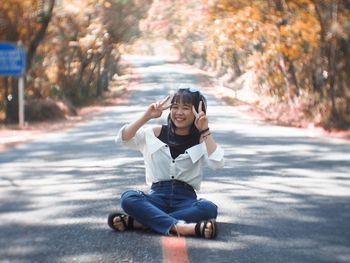 Portrait of girl sitting on road