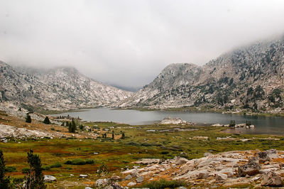 Scenic view of lake and mountains against sky