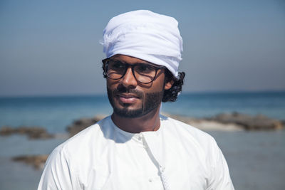 Portrait of man wearing turban on beach